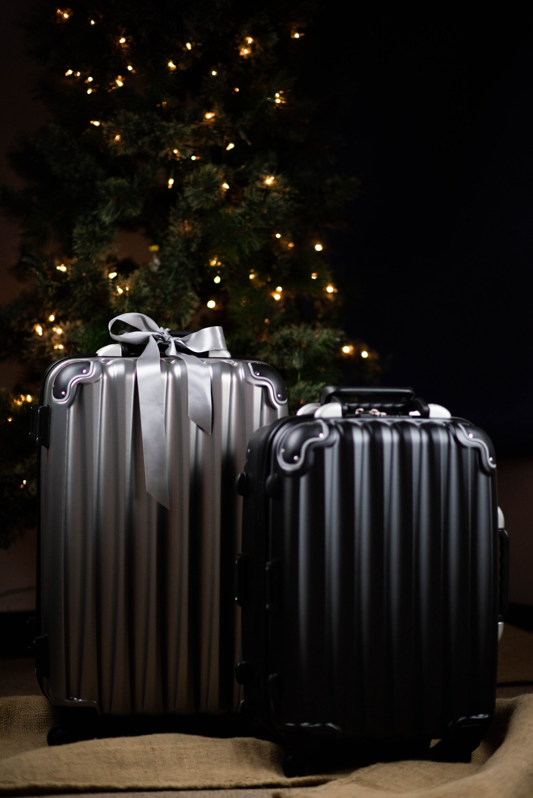Silver and black wine suitcases in front of Christmas tree
